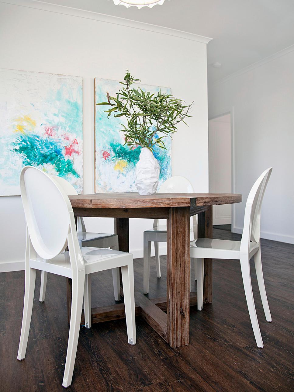 Turquoise Artwork in White Dining Room With Round Wood Table