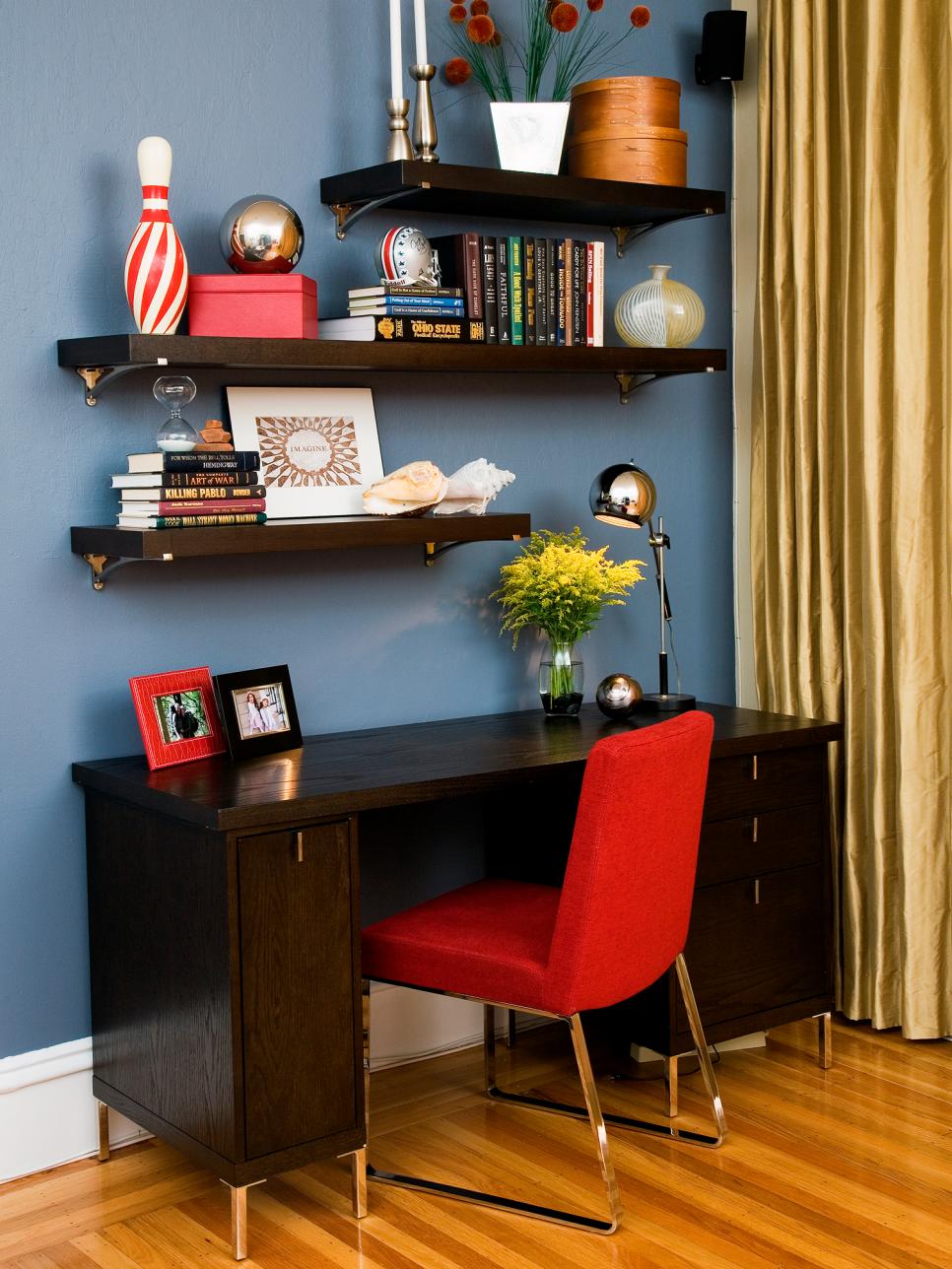 Contemporary Home Office With Floating Shelves and Red Chair