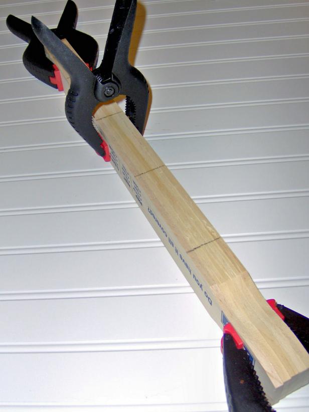 Clamp the paint sticks together in bundles and mark every 4 inches.
