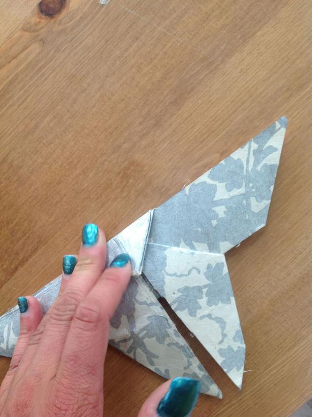 Continue to fold the triangle that is past the edge over.