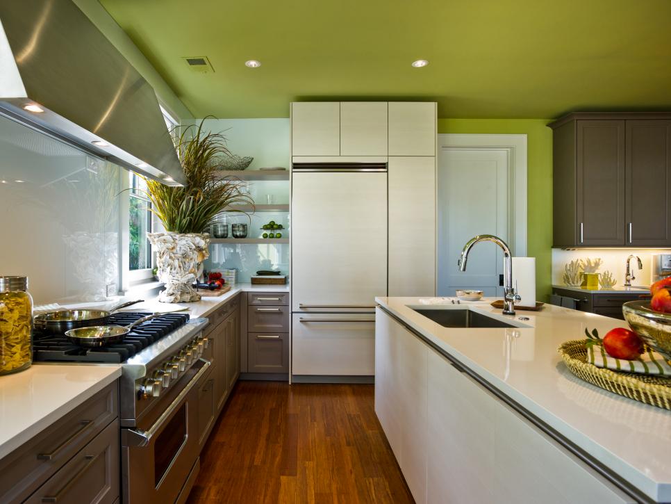 Green Modern Kitchen With Glossy White Countertops and Island