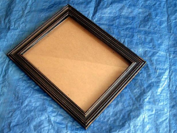 Start by removing the glass. Paint the outside part of your frame first. Consider using two different colors of paint and layering the colors. When you sand and distress, the bottom color shows through and makes it look weathered.