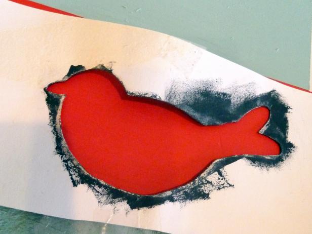 Find a dove stencil online by searching Google for “dove template.” Print and cut out a template. Place on top of your bottom board and spray carefully with white paint. Peel back the template to reveal the doves.