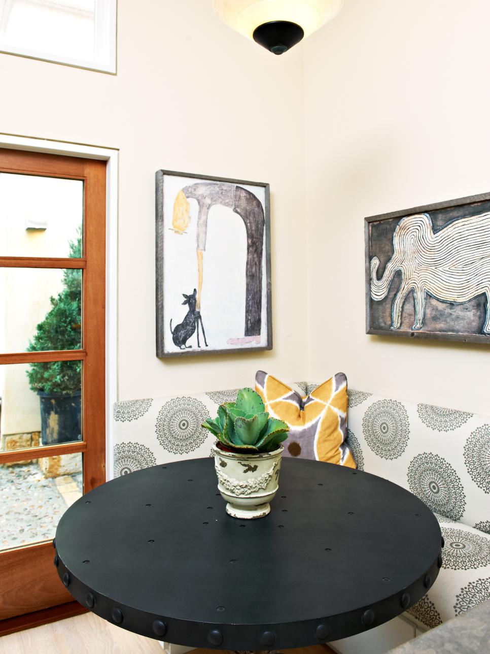 Breakfast Nook With Upholstered Banquette and Eclectic Art