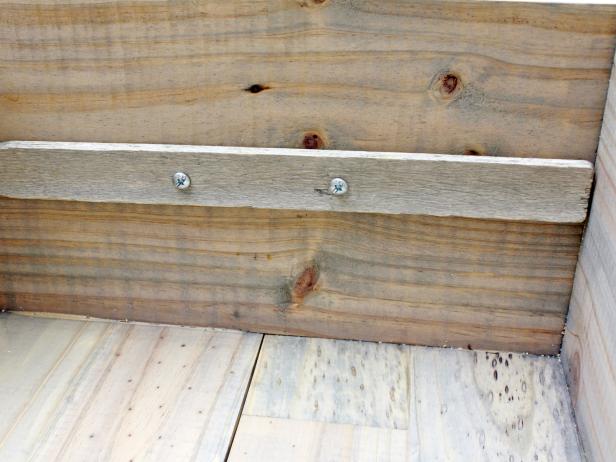 Apply a bead of glue on the paint sticks and place on the inside of the crate, in line with your screw holes. Now drill through those same holes again, this time going all the way through your sticks. Finish by screwing in your hardware.