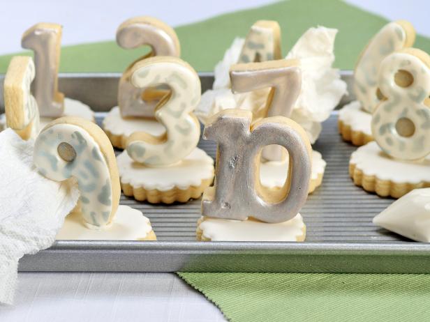 Add support with a piece of paper towel or plastic wrap propped up against the cookies while drying.