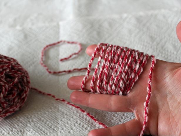 Wrap yarn around your fingers a dozen or so times. The more times you wrap it, the fuller the pom-pom will be.