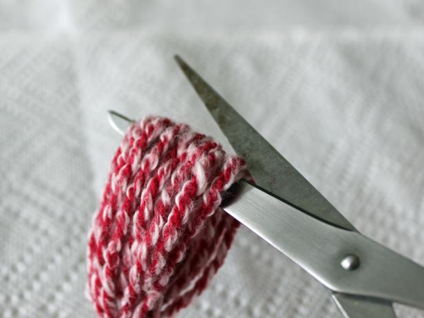 Cut the center of the loops after you have wrapped them around your fingers and knotted them together.