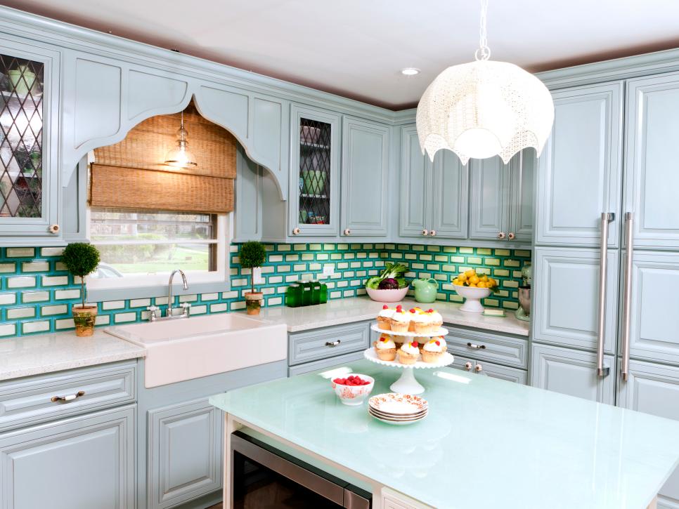 Blue cottage-style kitchen with colorful backsplash