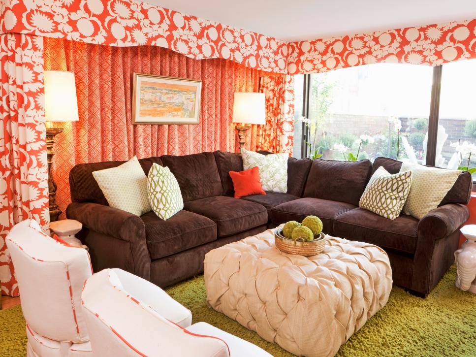 Family Room With Brown Sofa, Upholstered Ottoman and Coral Drapes