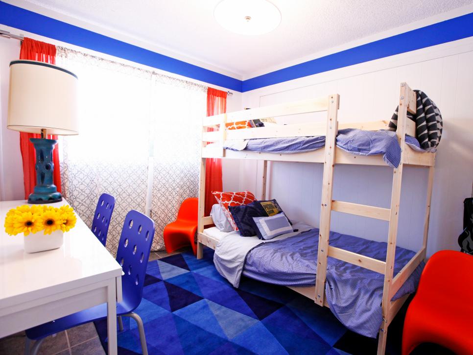 White Boys' Bedroom With Blue Geometric Rug, Red Curtains and Bunk Beds