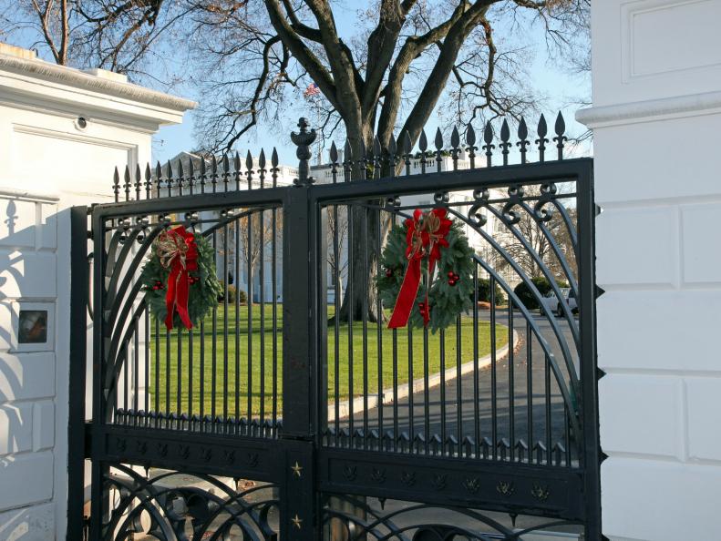 Iron Gates With Green and Red Holiday Wreaths
