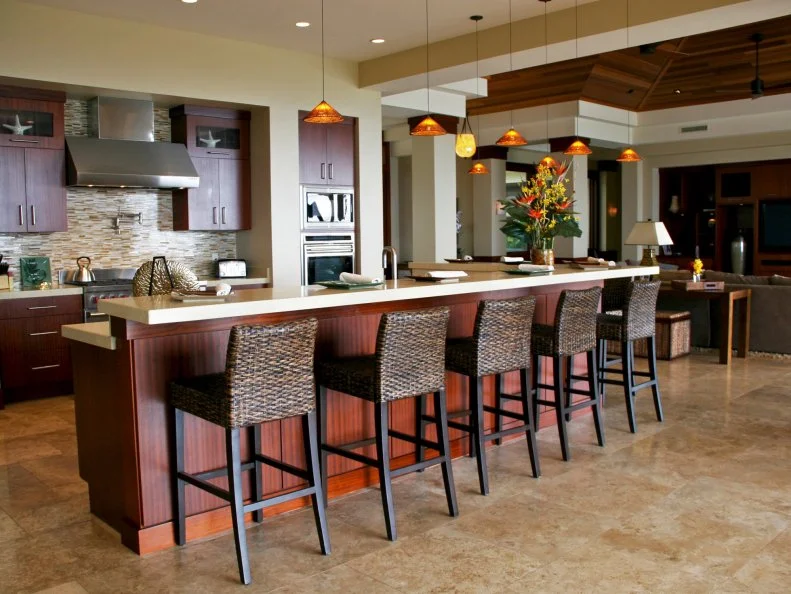 Contemporary, open kitchen with bar height peninsula in brown and tan. 