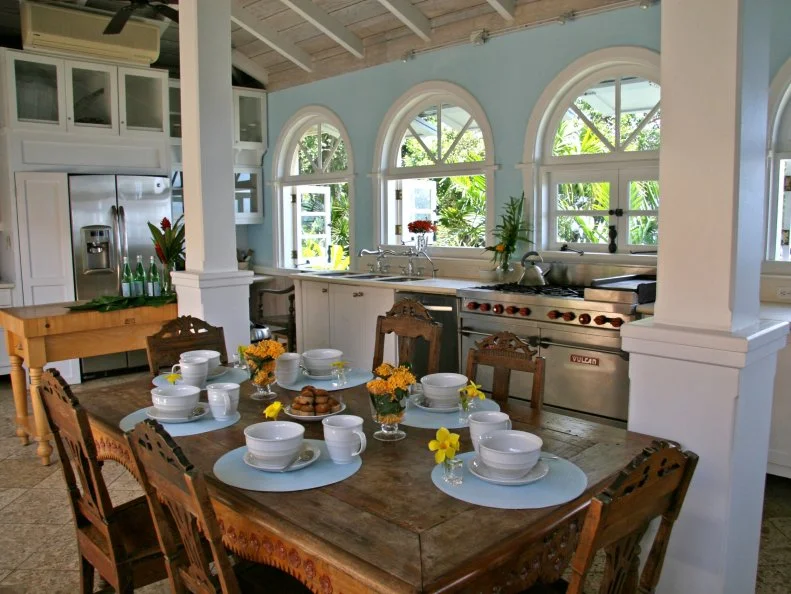 Blue Kitchen With White Exposed Beam Ceiling and Rustic Wood Table