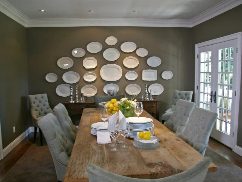 Neutral Country Dining Room With Wood Table and Plate Wall Art