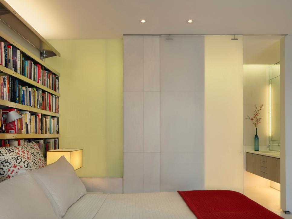 Soft Green Bedroom With Translucent Walls and Bookshelves