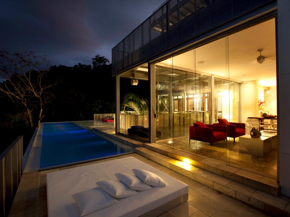 Swimming Pool and Patio With Glass Wall Looking Into Living Room