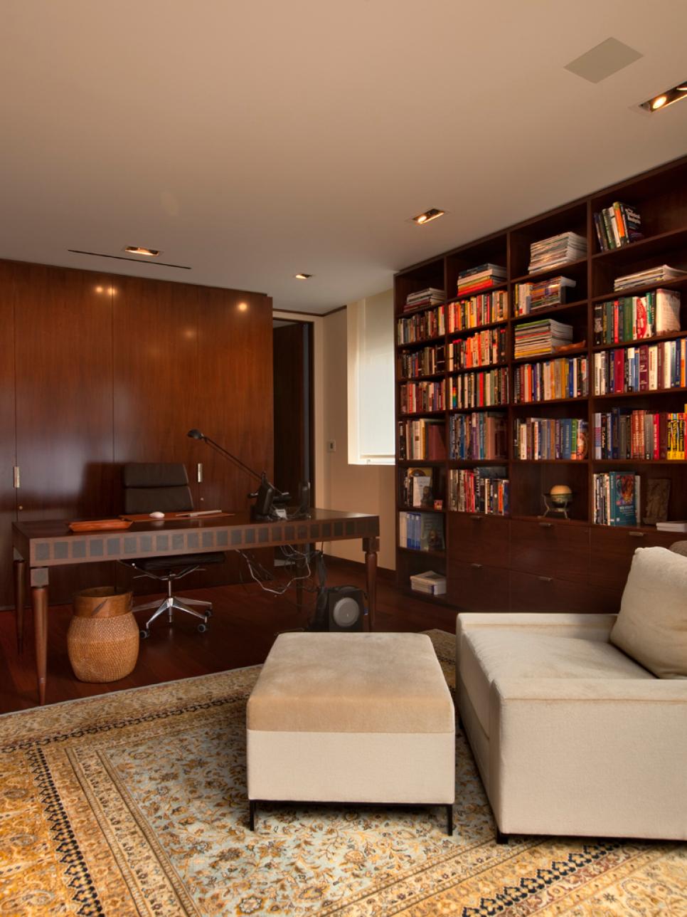 Traditional Library With Floor-to-Ceiling Bookshelves and Area Rug