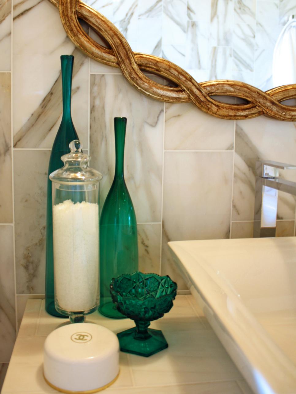 Bathroom With Marble Tile and Green Glass Vases