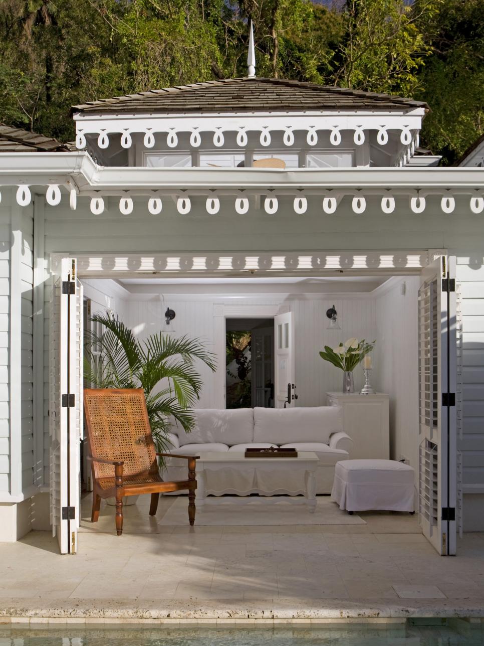 Indoor/Outdoor Room With Wood Shutter Doors White Indoor/Outdoor Room With Tropical Plant