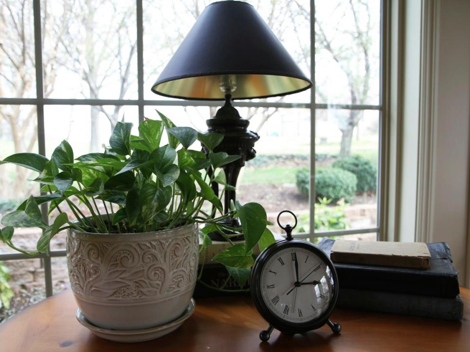 Traditional Living Room Window Table With Black Lamp and Clock