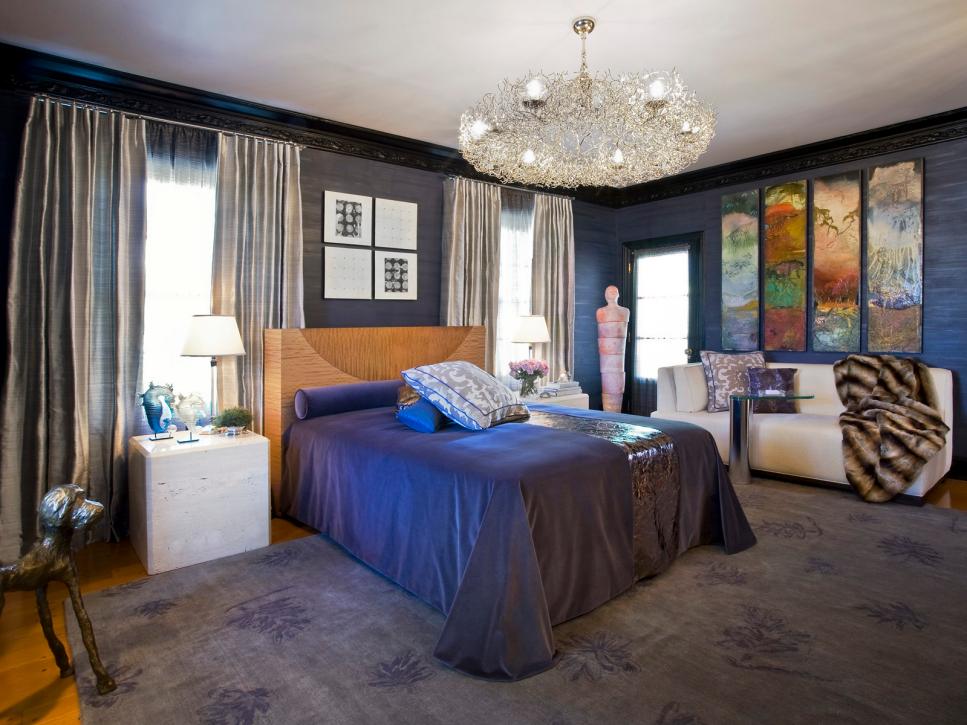 Dark Blue Bedroom With Large Ceiling Light and Colorful Wall Art