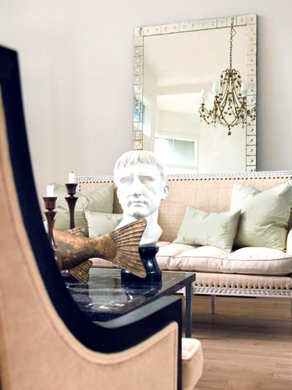 Neutral Living Room With Oversize Mirror and Sculptures