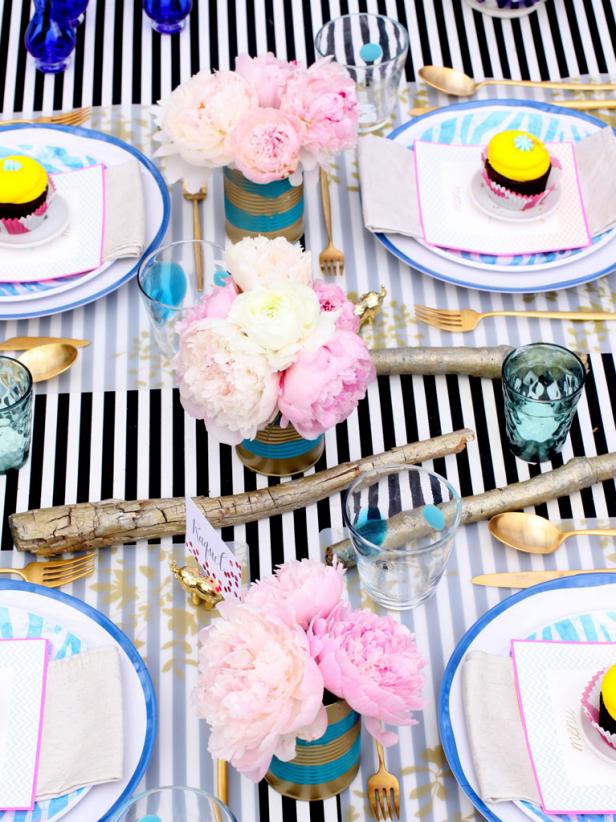 Much like hosting a get-together at home, when setting up a dinner table outdoors, decide on a color palette and chose elements that require minimal fuss. Set up folding tables for the buffet station and dinner table.