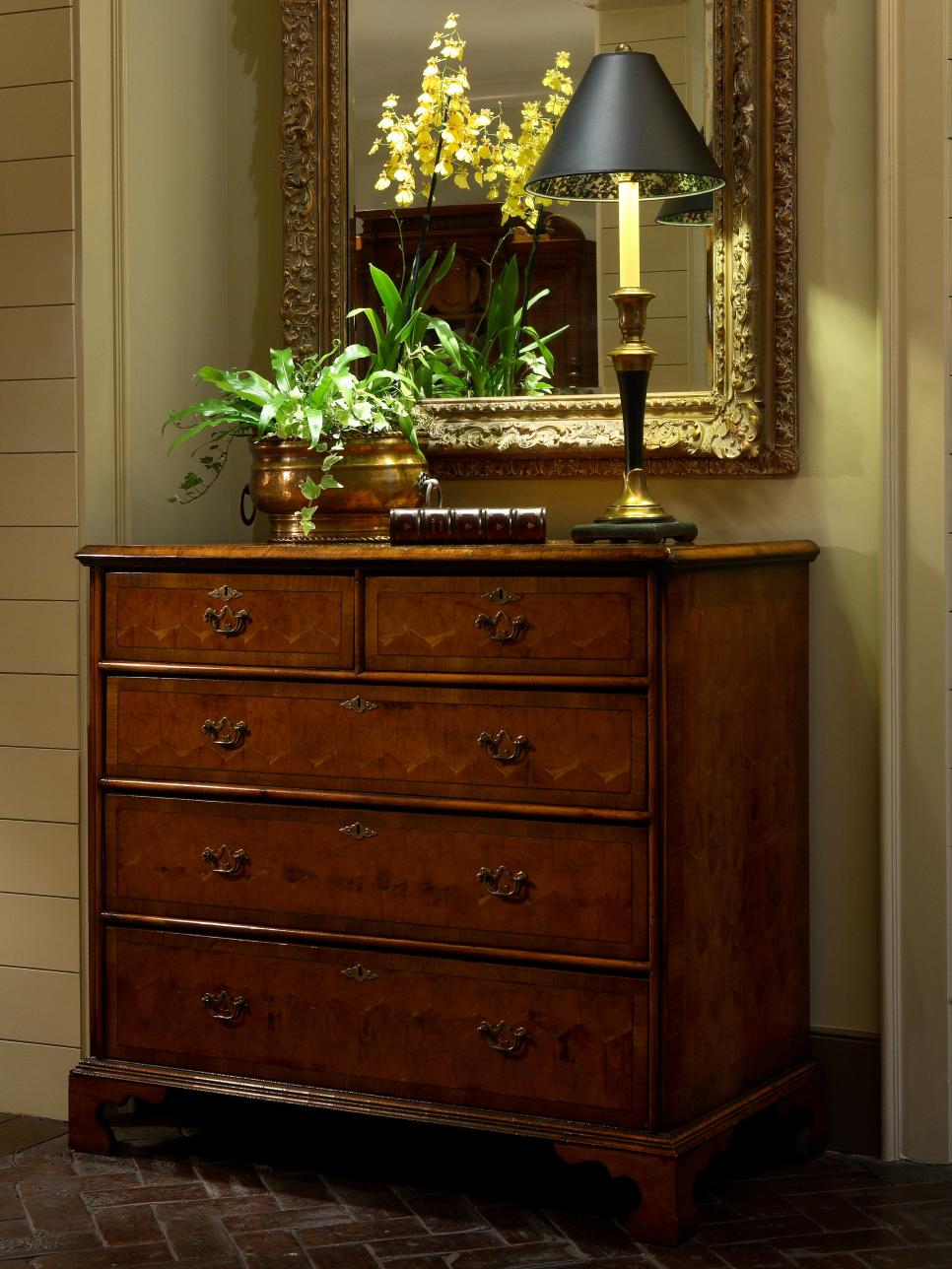 Entryway With Wooden Antique Chest, Brass Lamp and Orchid Arrangement