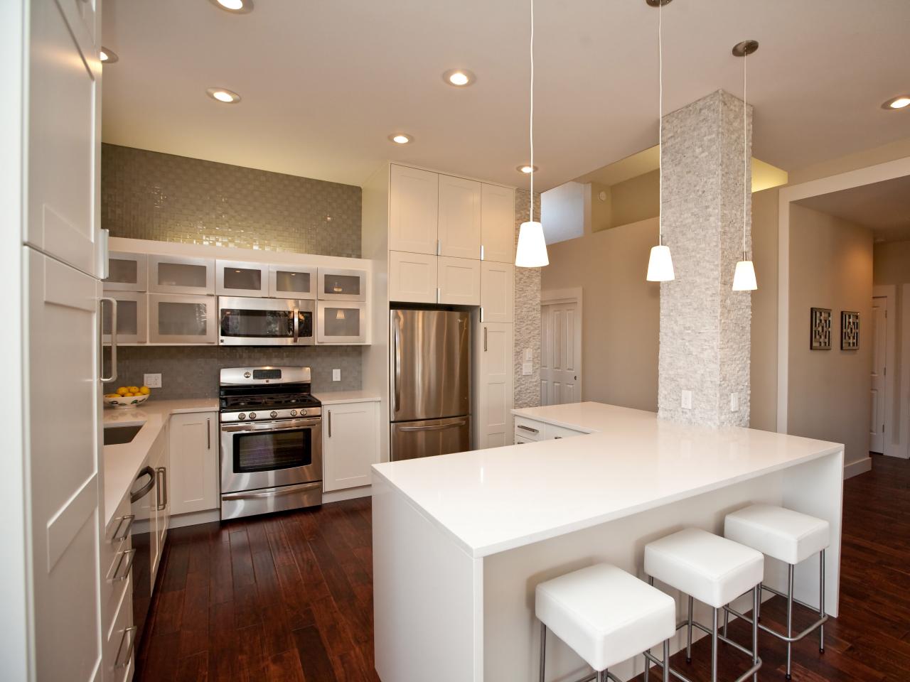 Modern White Kitchen Set on Hardwood Floors in an Open