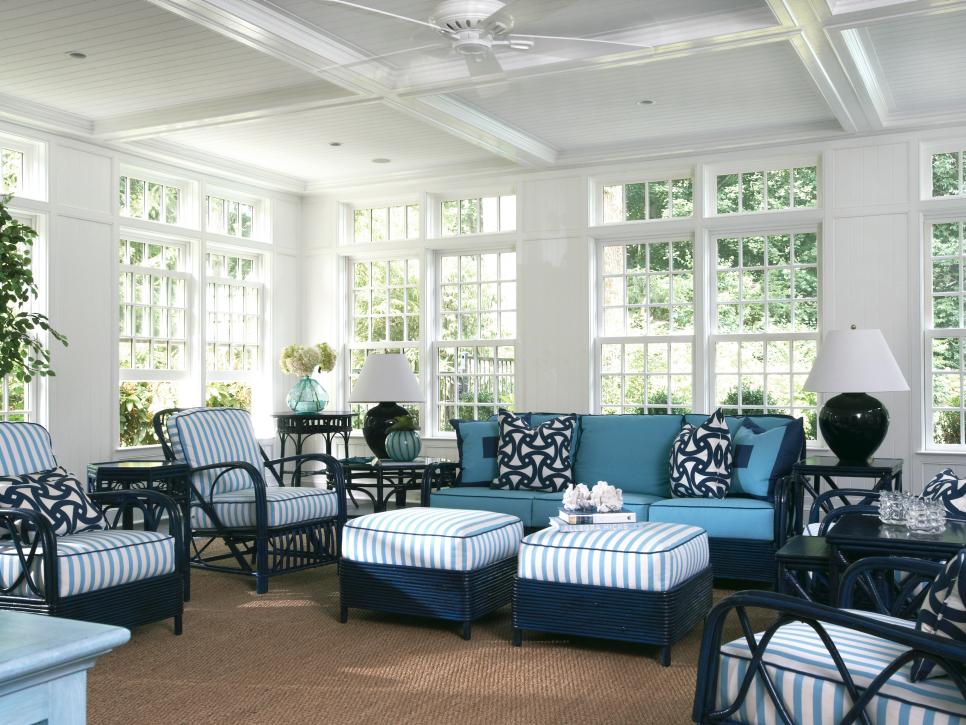 White Sunroom With Navy Wicker Furniture & Sisal Carpeting 