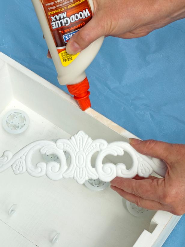 Using the wood glue, attach the trim pieces to the top front edges of each crate and let dry (Image 3).