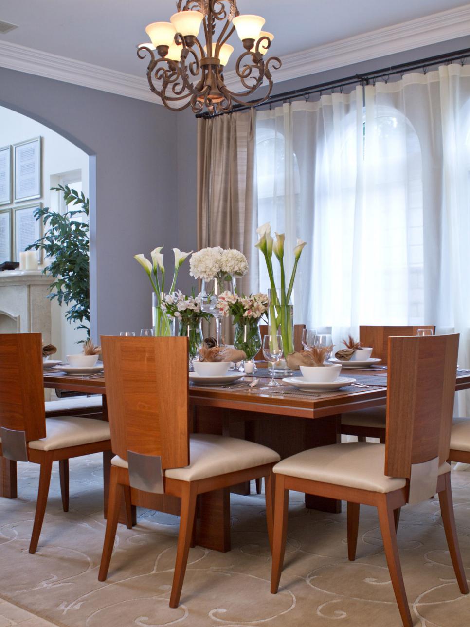 Bright Transitional Dining Room With Chandelier and Contemporary Chair
