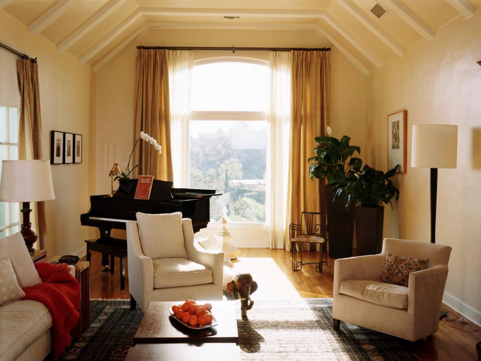 Warm Living Room with Large Arched Window and Traditional Furnishings