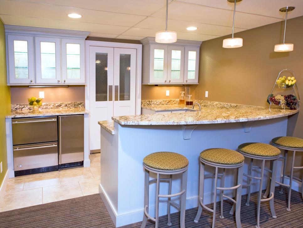 Basement Bar With White Cabinets and Stainless Steel Appliances