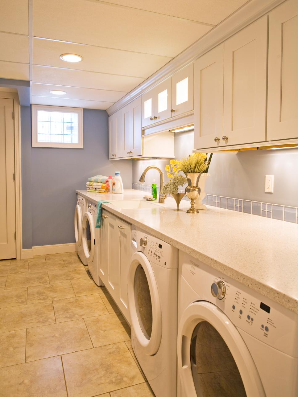Large Laundry Room With White Cabinetry, Appliances and Counters