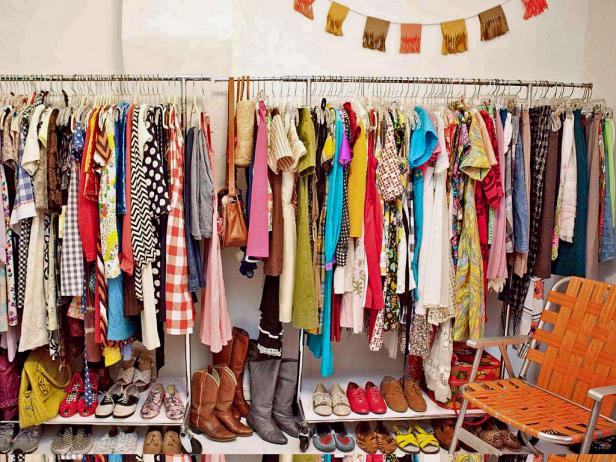Cluttered, Full Closet With Hanging Clothes and Shoe Shelves Cluttered, Full Closet With Hanging Clothes and Shoe Shelves