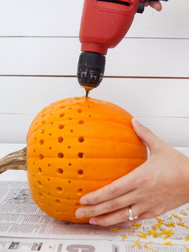 Use hand-held drill to make holes in pumpkin. Be sure to drill all the way through the pumpkin flesh, otherwise the candle light will not shine through.