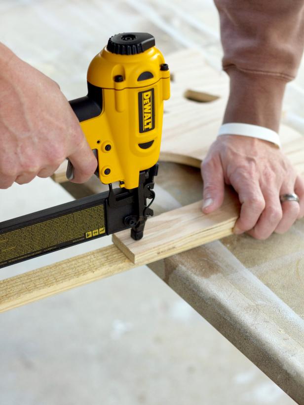 Flip the cat over, and use a pneumatic nailer to further secure the stake to the cat from the front side.