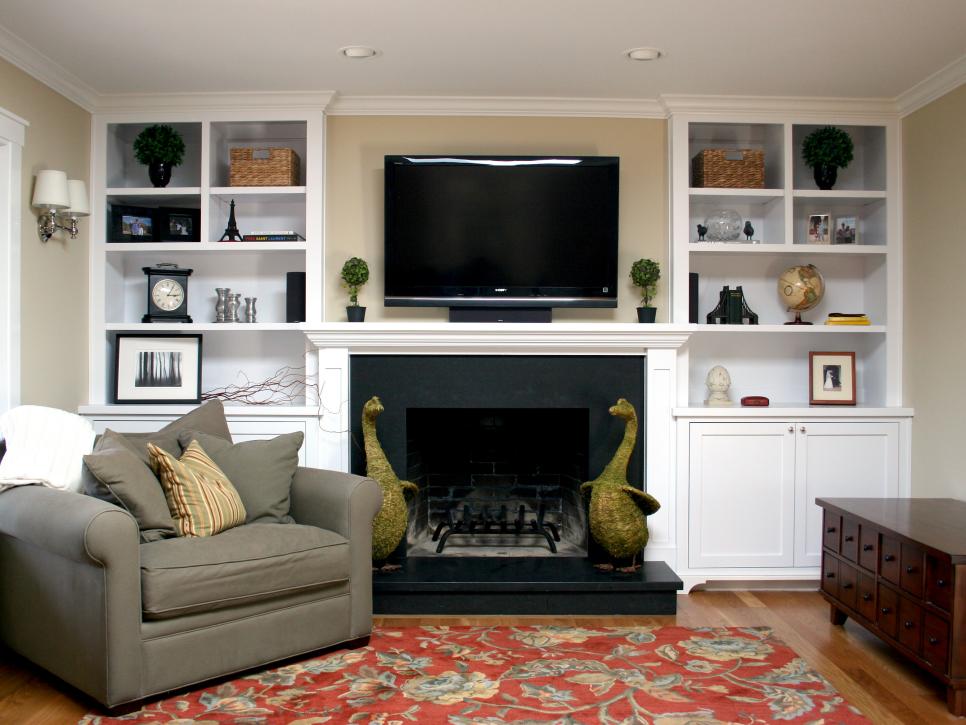 Neutral Living Room With Red Area Rug and White Built-In Bookshelves
