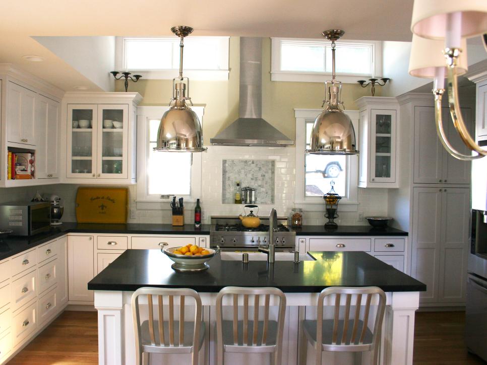 Transitional Black-and-White Kitchen with Metal Lamps and Stools