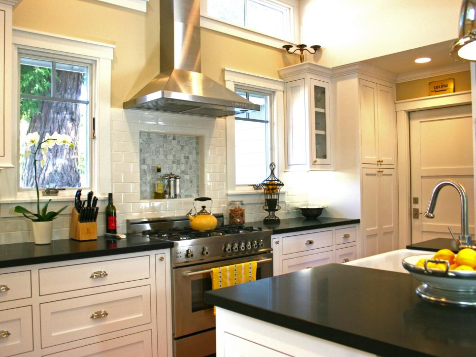 Transitional Kitchen With White Cabinetry and Black Countertops