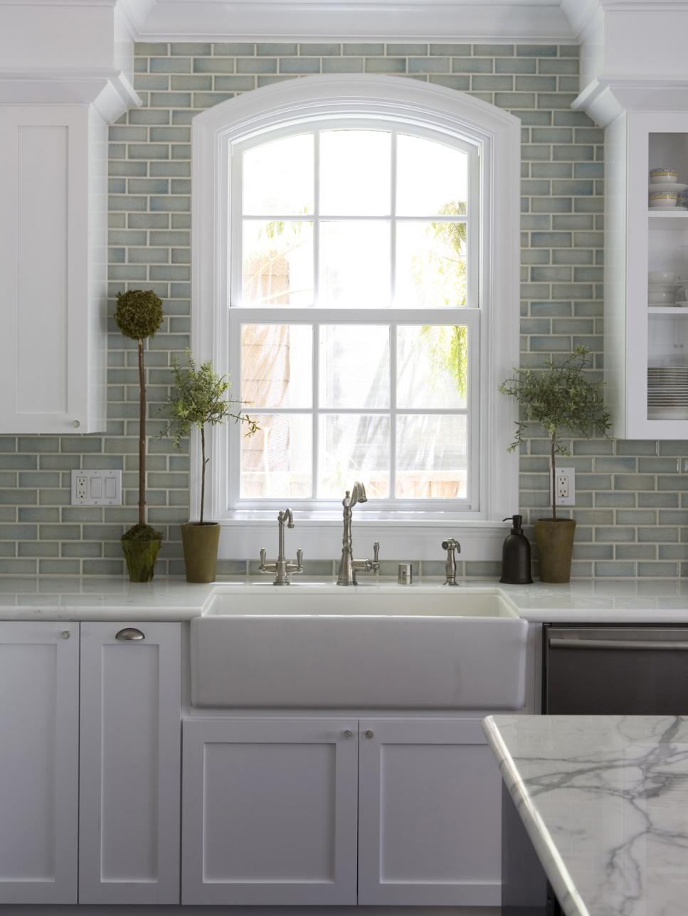 Green Kitchen With White Cabinetry and Subway-Tile Backsplash
