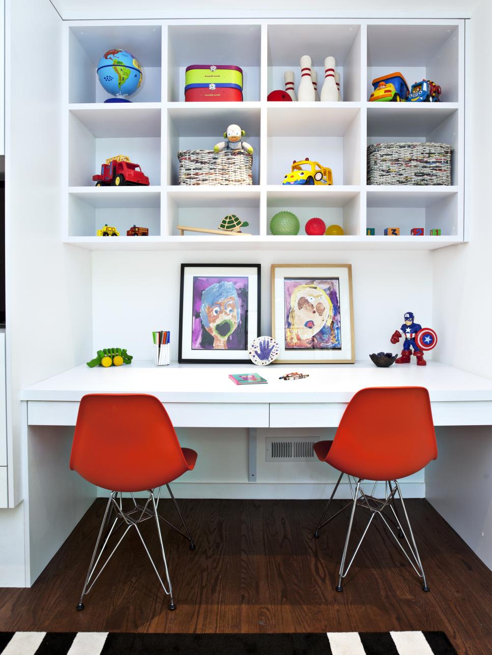 White Kid's Built-In Desk and Open Shelves With Red Chairs