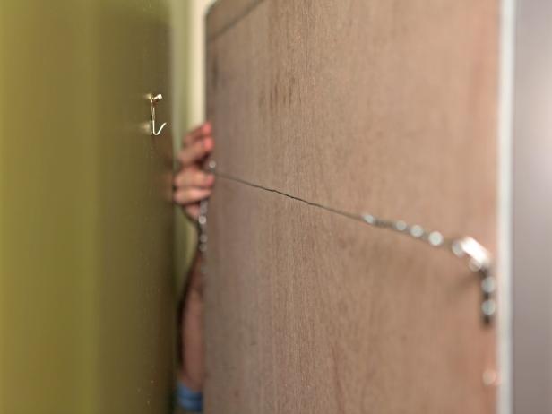 With proper height marked, add weight-rated picture hangers to the wall with a hammer or drill, then hang mirror with newly attached hardware.