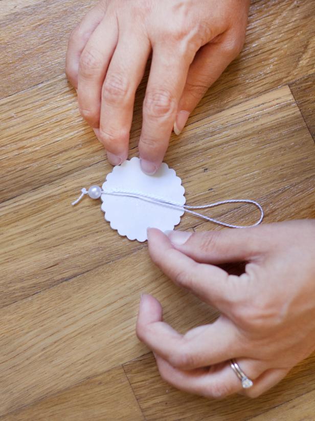 Use Adhesive to Attach Twine to Card Stock Ornament Use Adhesive to Attach Twine to Card Stock Ornament