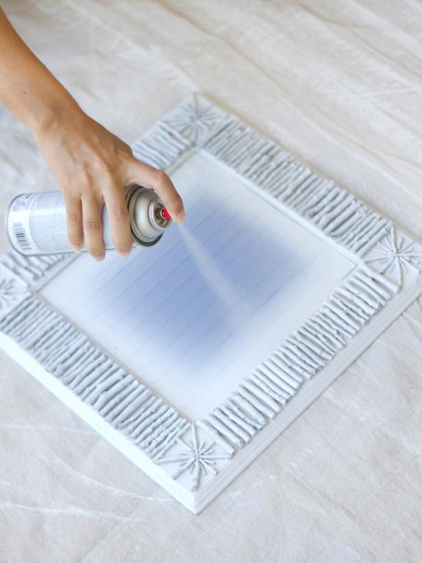 Evenly coat the mirror frame with white spray paint.