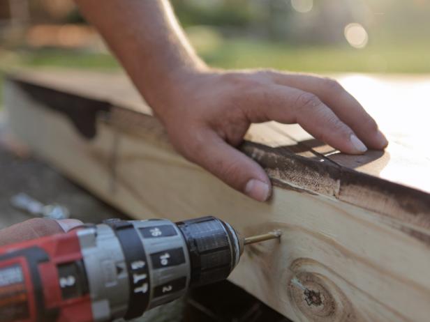 Drill two holes into the top of each frame for attaching C-hooks, spaced approximately 6 inches in from the outside edge.