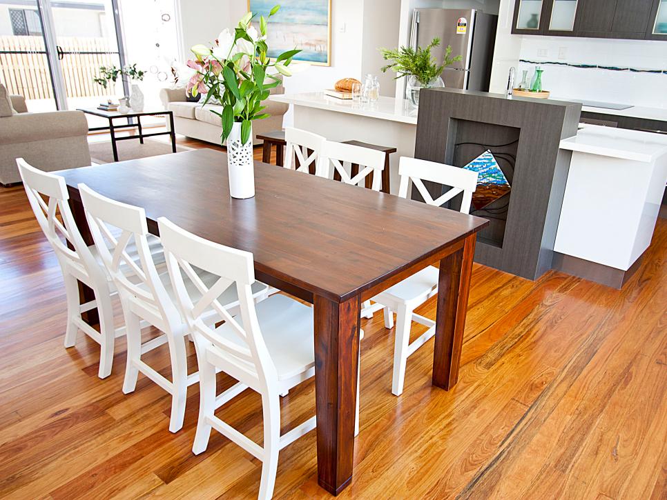 Transitional Open-Plan Dining Room and Kitchen With White Chairs