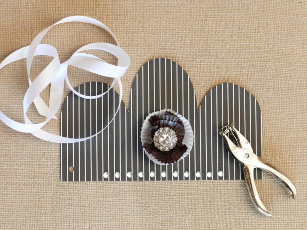 Using a standard hole punch, punch each side of the crown about 1/2" in to accommodate ribbon. Insert the ribbon through holes, then knot to secure.